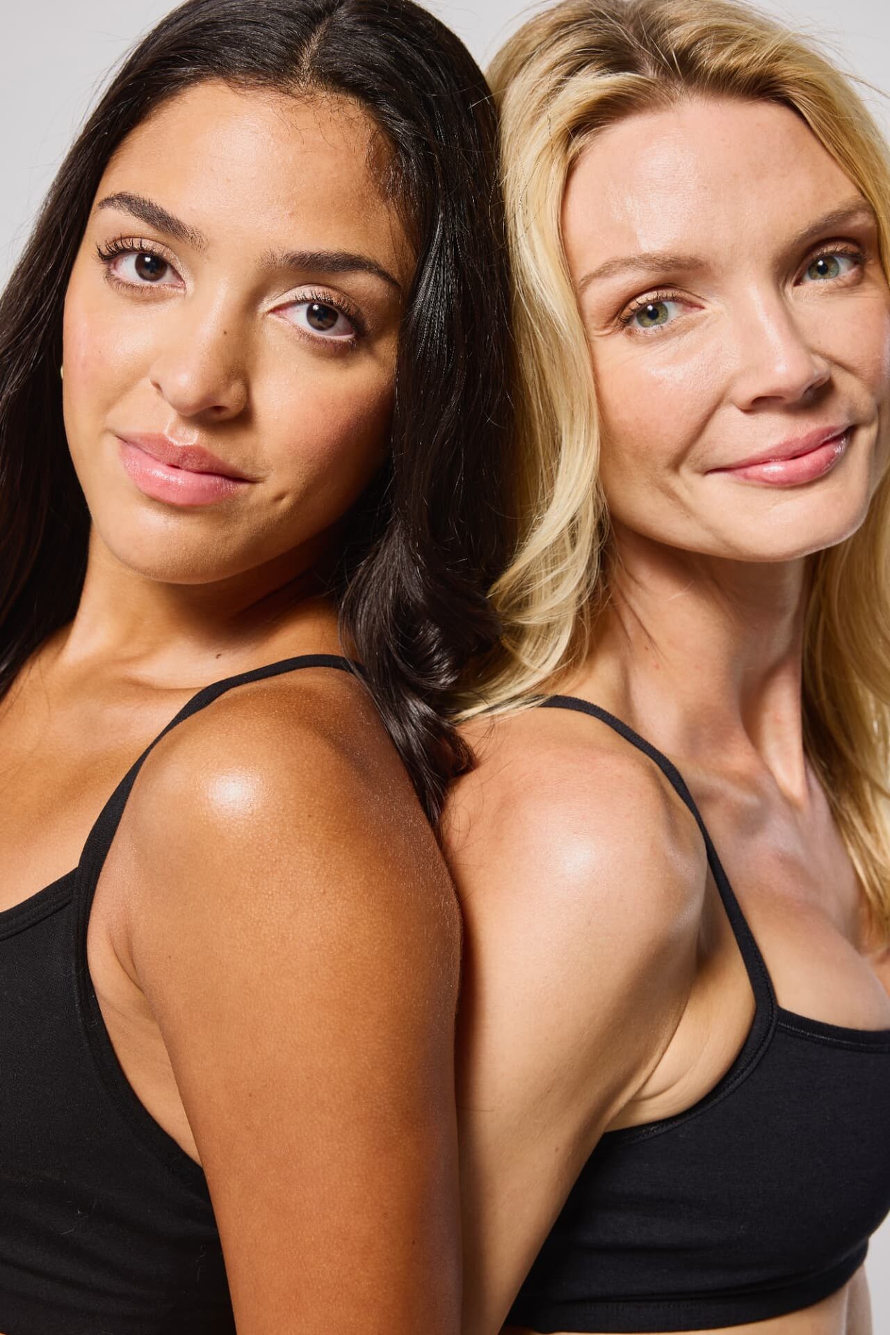 Two women with natural-looking goGLOW airbrush tans